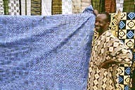 Ghana: Ntonso (Ashanti Region), man showing Adinkra cloth