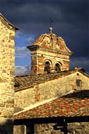 Italy: Tuscany, Lucignano, brick bell tower and terracotta tile roof