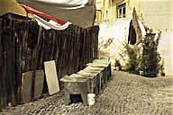 Portugal: Lisbon, Bairro Alto, hanging laundry blowing in wind above washing bins