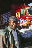 Dairy farmer Mr. Ndirungu, in front of Brookside truck.