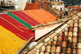 Tarps over bombed-out buildings