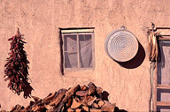 New Mexico: Acoma Pueblo, peppers, wash tub, and corn hanging on wall of adobe house