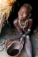 Duss, a Karo tribal village, older woman in her hut offering coffee