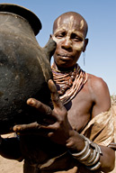 Duss, a Karo tribal village, woman holding black cooking pot
